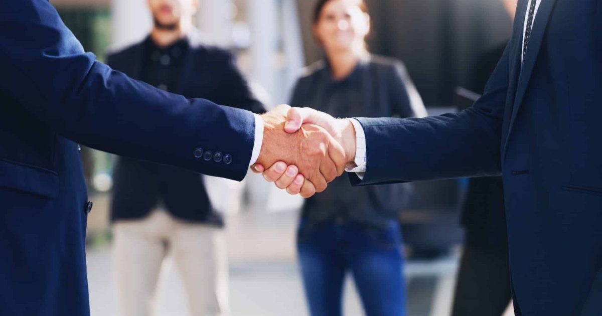 Cropped shot of two unrecognizable businesspeople shaking hands while in the office during the day.